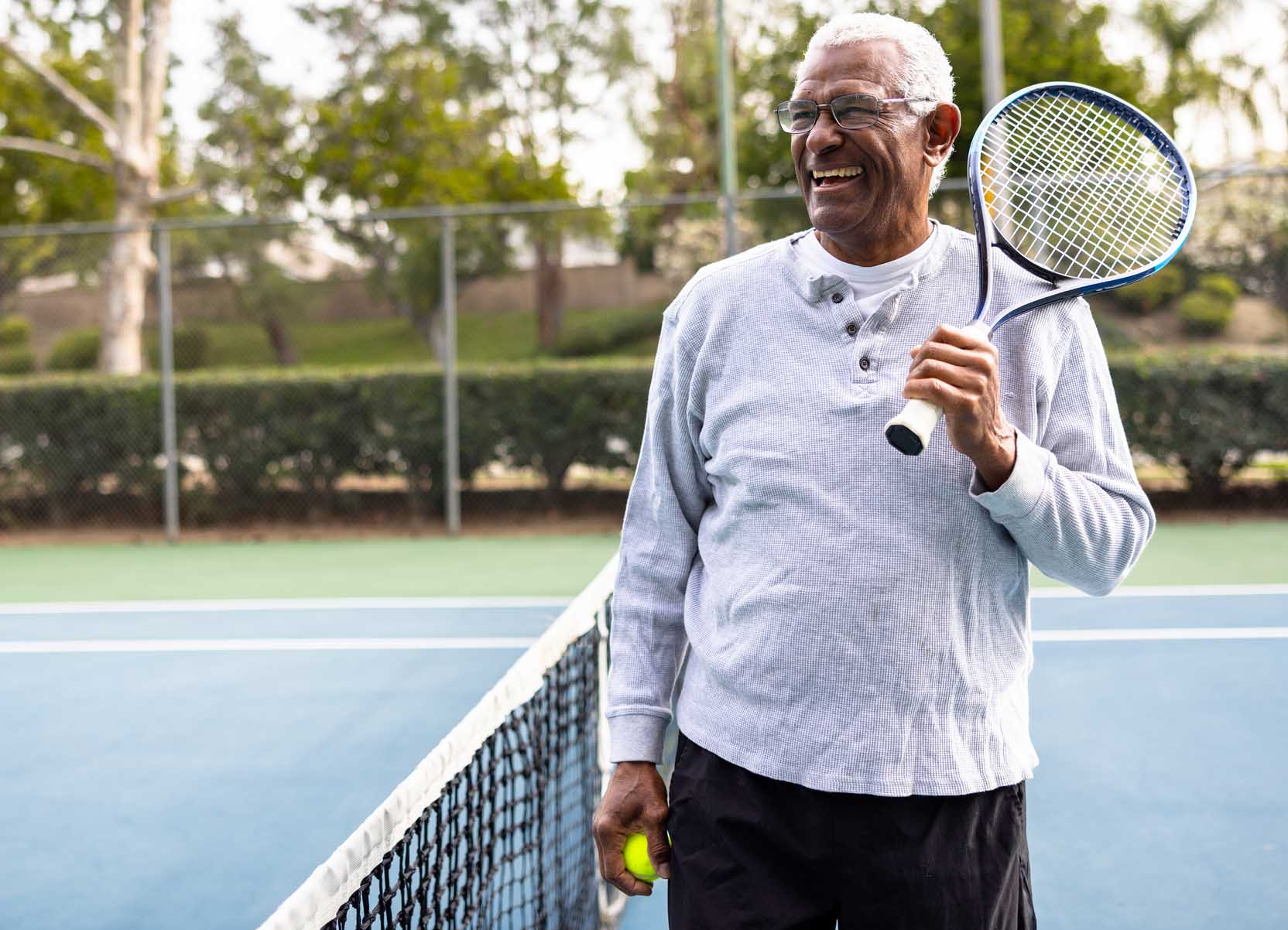 Senior man playing tennis